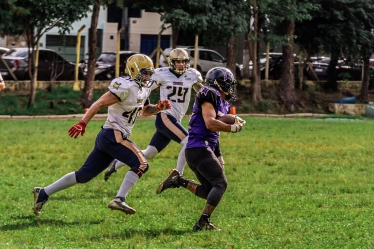 Vibrant image capturing an intense American football game with players in full motion on a green field.