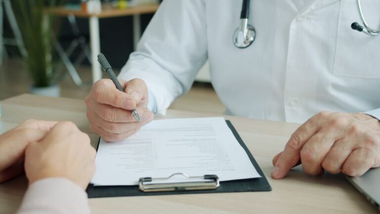 Doctor reviewing test results with a patient during a consultation about unexplained symptoms