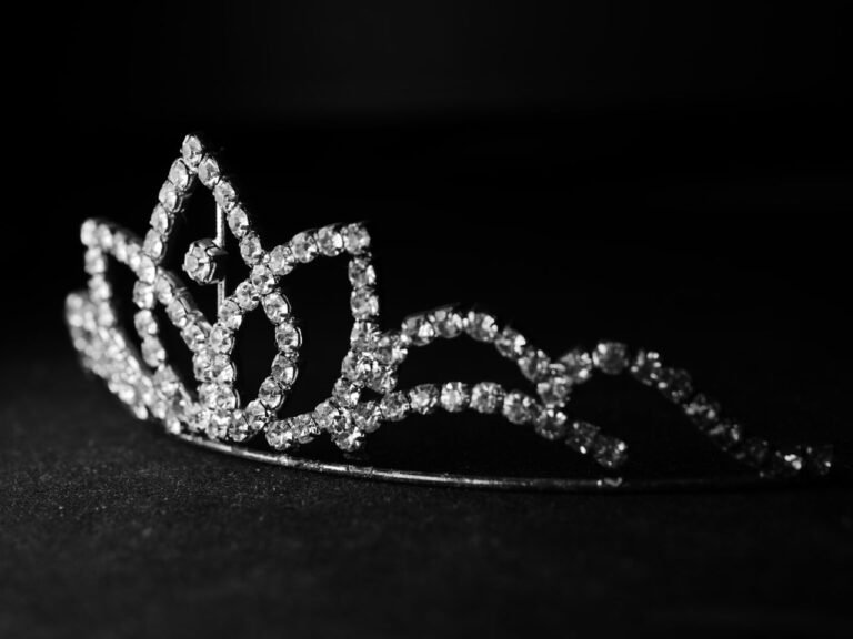 Close-up of a luxurious diamond tiara against a dark background, showcasing elegance and luxury.
