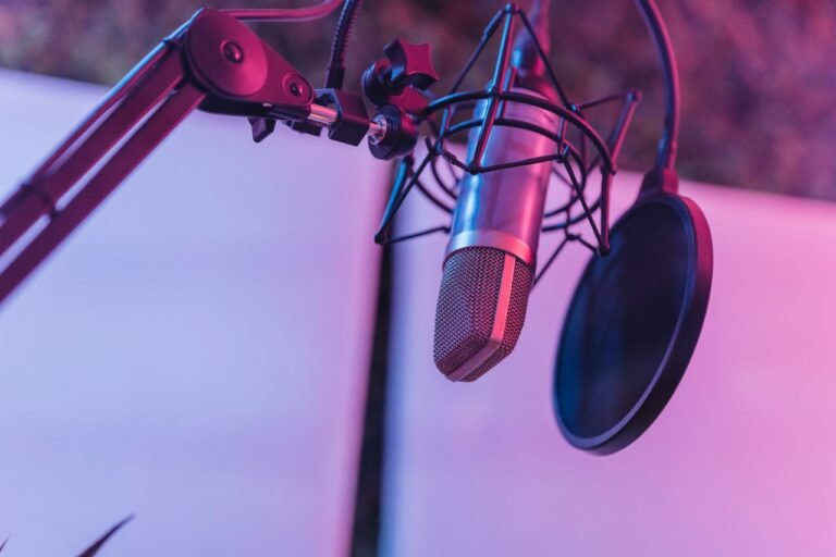 A close-up view of a microphone in a vibrant studio environment, ideal for podcasts and voice recording.